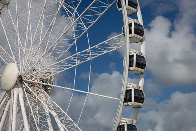 Low angle view of ferris wheel against sky