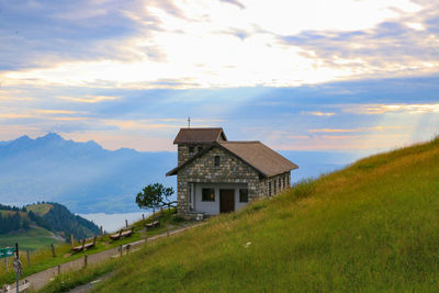 Houses on field against sky