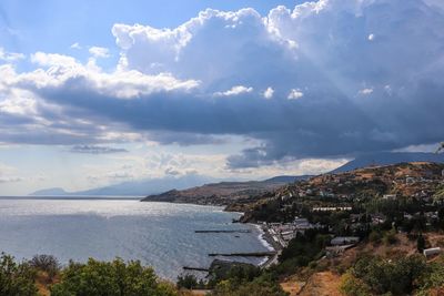 High angle view of townscape by sea against sky