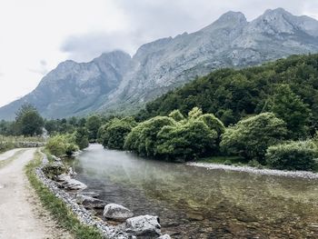 Scenic view of river amidst mountains against sky