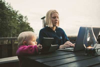 Women sitting on table at home