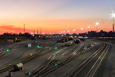 High angle view of illuminated city against sky during sunset