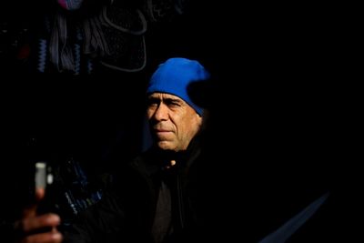 Portrait of man holding camera at night