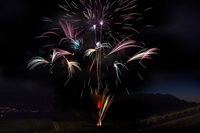 Low angle view of firework display at night