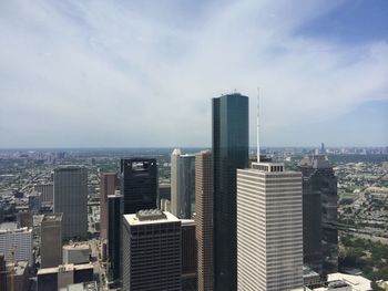 Skyscrapers against cloudy sky