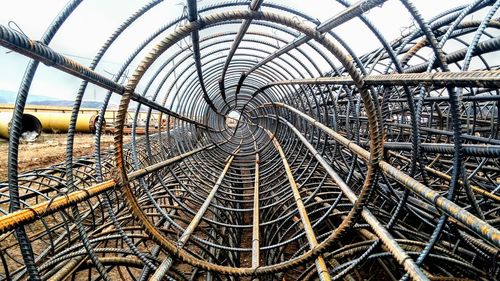 Close-up of metallic structure against sky