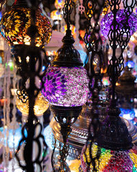 Close-up of illuminated lanterns hanging on glass