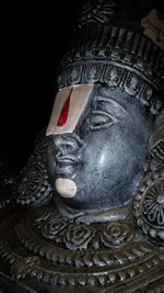 Close-up of statue against black background