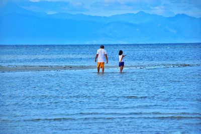 People on beach against sky