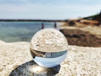 Close-up of water on beach against sky