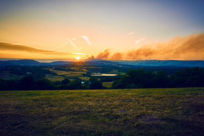 Scenic view of land against sky during sunset