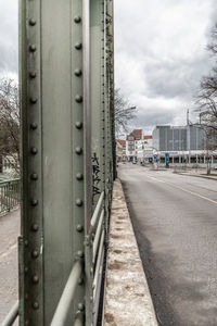 Metallic structure in city against sky