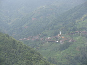 Scenic view of village by mountains