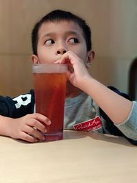 Portrait of boy drinking coffee