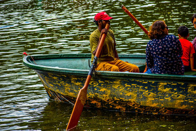 People sitting in boat on lake