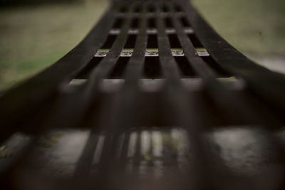 Close-up of metal bench in park