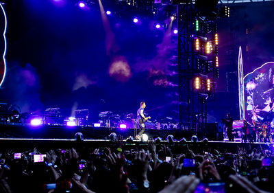 People enjoying music concert at night