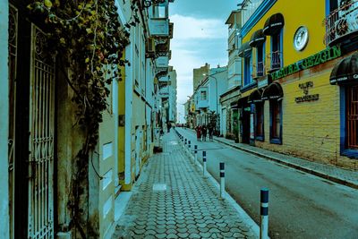 Empty alley amidst buildings in city