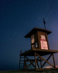 Low angle view of lifeguard hut against star field