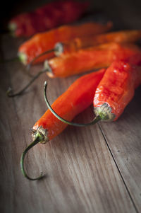 Close-up of red chili peppers on wooden table