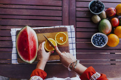 Directly above shot of woman holding fruits