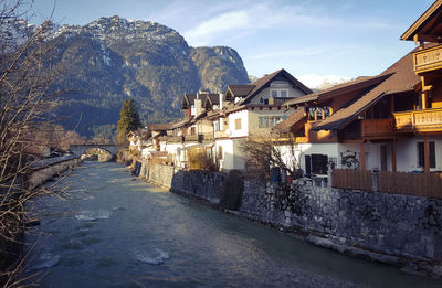 Houses in town against sky during winter