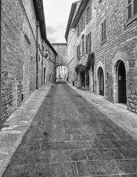 Empty alley amidst buildings in city