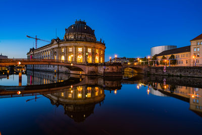 Reflection of illuminated buildings in water at night