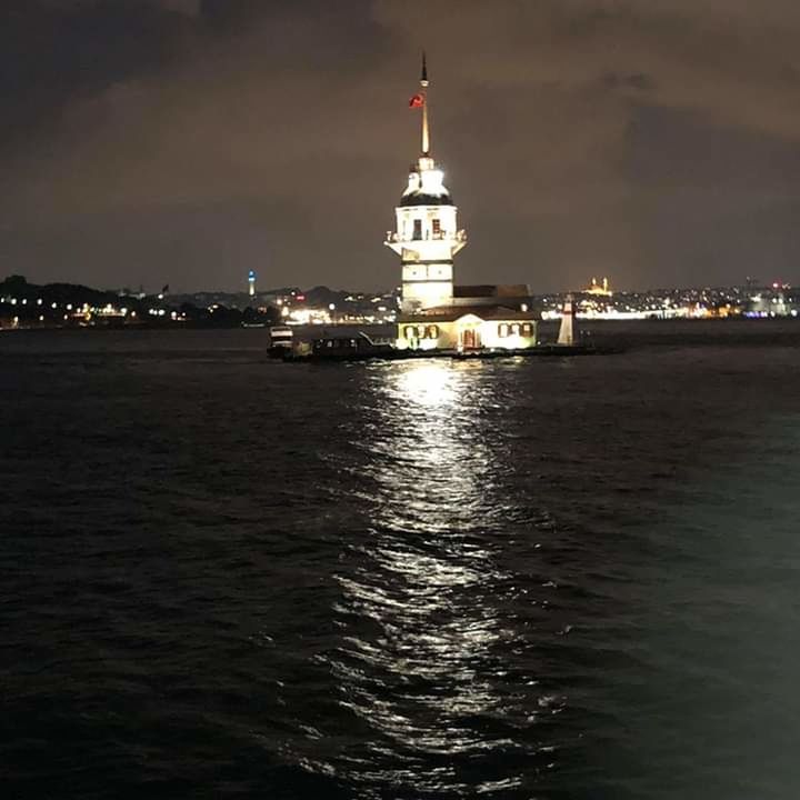 ILLUMINATED BUILDING AT WATERFRONT