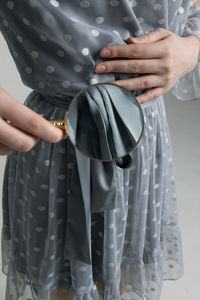 Midsection of woman holding umbrella