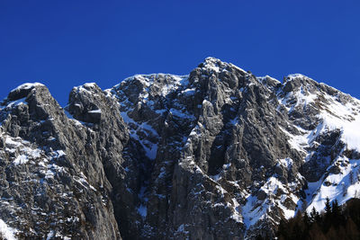 Scenic view of snowcapped mountains against clear blue sky