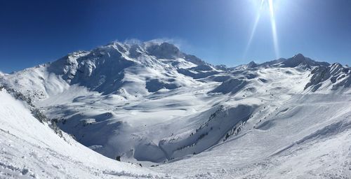 Scenic view of snowcapped mountains against clear sky