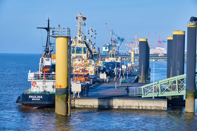 Commercial dock by sea against sky