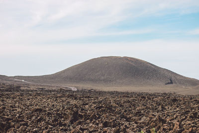 Scenic view of arid landscape against sky