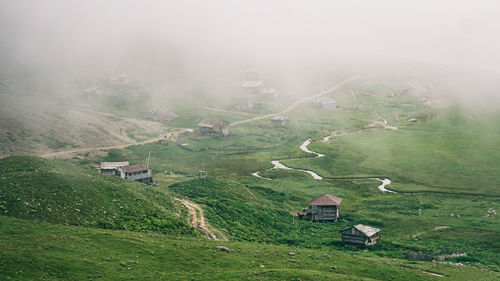 Houses on field by village