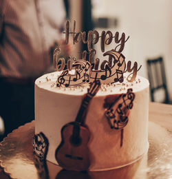 Close-up photo of birthday cake with music theme decorations