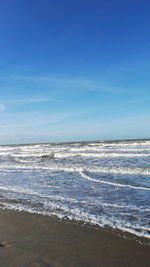 Scenic view of sea against blue sky