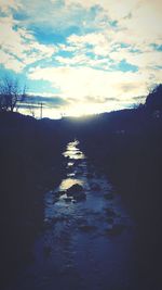 Scenic view of river against sky at sunset