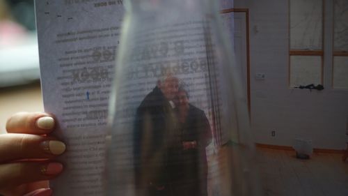 Midsection of person holding book