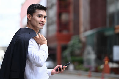 Portrait of businessman using mobile phone