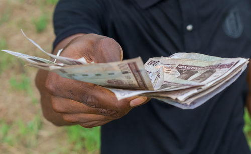 Close-up of hand holding paper