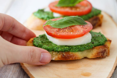 Close-up of hand holding burger