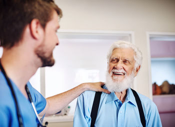 Doctor consoling patient in clinic