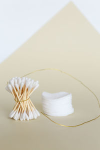 High angle view of paper tied on table against white background