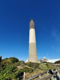 Low angle view of factory against blue sky