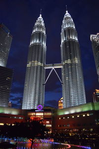 Low angle view of illuminated buildings against sky at night