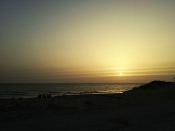 Scenic view of sea against clear sky during sunset