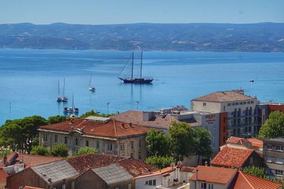 High angle view of buildings by sea against sky