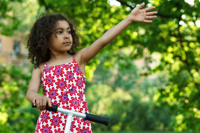 Girl looking away while standing at park