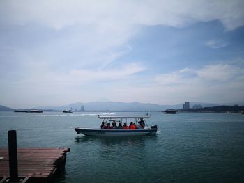 Boats in sea against sky